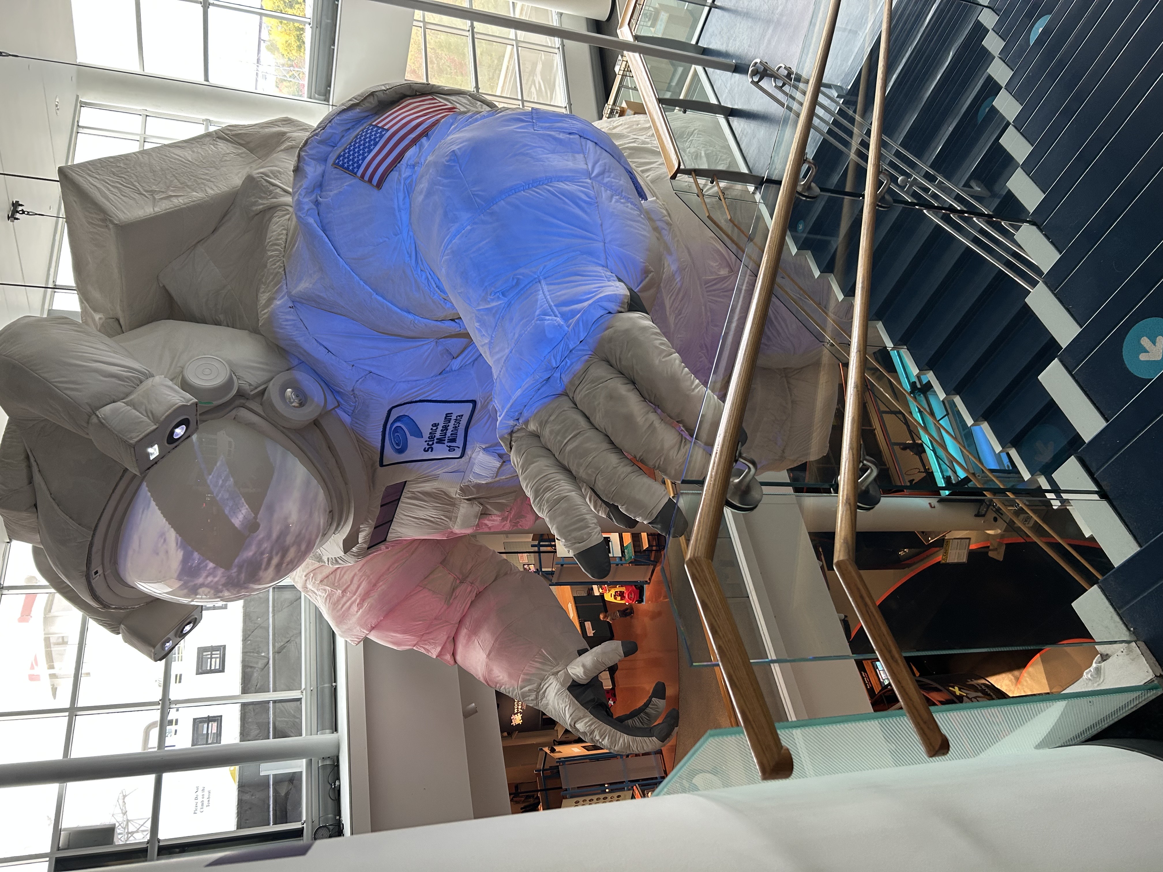 gigantic inflatable astronaut, hanging over a stairwell